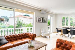 a living room with a couch and a table at Large villa near beach, sea view, islands & bay of Cannes, 7 bedrooms in Cannes