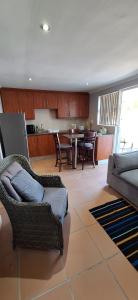 a living room with a couch and a table at Firehouse selfcatering Garden Cottages no 5 in Wellington