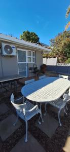 a table and chairs sitting on a patio at Firehouse selfcatering Garden Cottages no 5 in Wellington