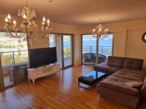 a living room with a couch and a flat screen tv at Harmonia Budva 1 in Budva