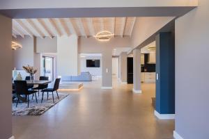 a dining room and living room with a table and chairs at Villa Athina Corfu - 4 bedrooms in Kynopiástai