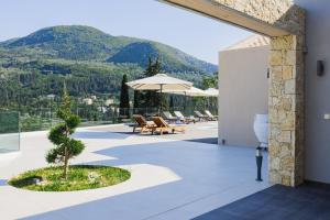 a patio with a view of a mountain at Villa Athina Corfu - 4 bedrooms in Kynopiástai
