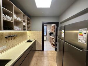 a kitchen with a sink and a refrigerator at STARS University Dormitory in Tashkent