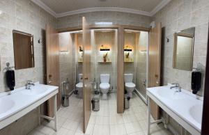 a bathroom with two sinks and two toilets at STARS University Dormitory in Tashkent +64 photos