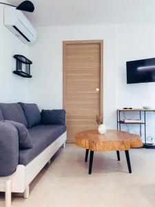 a living room with a couch and a table at Coco, Elegance and Serenity in Collioure in Collioure