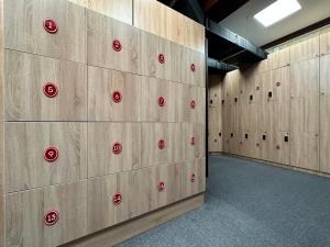 a row of lockers in a gym with red buttons at STARS University Dormitory in Tashkent