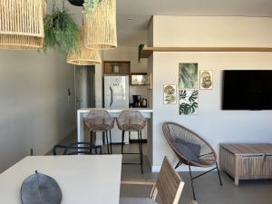 a living room with chairs and a table and a counter at Apartment by the sea Torres Parque da Guarita in Torres