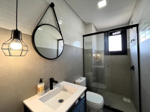 a bathroom with a sink and a mirror and a toilet at Apartment by the sea Torres Parque da Guarita in Torres +42 photos