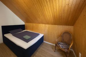 a small room with a bed and a chair at Unser Harztraum in Blankenburg