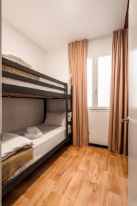 a bedroom with two bunk beds and a window at Bob W Madrid Atocha in Madrid