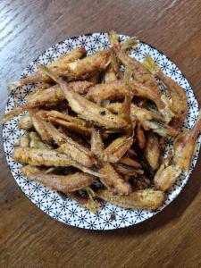 a plate of french fries on a wooden table at I Love Koman Camping in Shkodër