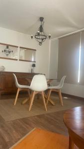 a dining room with a table and two chairs at Armação de Pêra Vista Mar in Armação de Pêra