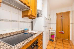 a kitchen with a sink and a refrigerator at Apartament Garrota in Olp +16 photos