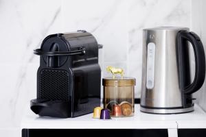 a coffee maker sitting on a shelf next to a coffee pot at Le SEPT MARTINE Hyper centre - Air-conditioned - Terrace - Quiet - Wifi - Tramway in Nice