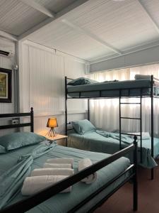a bedroom with two bunk beds and a lamp at Matea Room in Himare