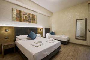 Ένα ή περισσότερα κρεβάτια σε δωμάτιο στο Relais Tiburtina