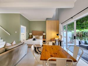 a living room with a bed and a table at Oasis in Seapoint in Cape Town