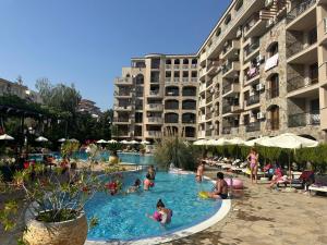 a group of people in a swimming pool at a hotel at Kalia A7 Sunny Beach in Bŭnzareto