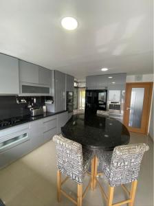cocina con mesa y 2 sillas en Nazaré Luxury Villa with Private Pool, en Nazaré