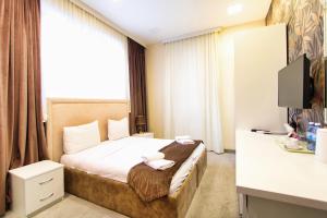 Postel nebo postele na pokoji v ubytování Sunday Boutique Hotel