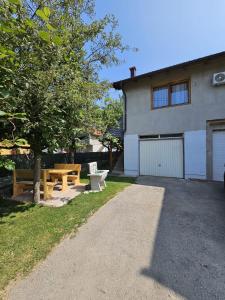 a house with a picnic table and a building at Apartman Behar in Sarajevo +22 photos