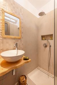a bathroom with a sink and a shower at Nisea Hotel Samos in Pythagoreio