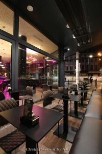 a restaurant with tables and chairs in a building at Hôtel de l'Univers Liège in Liège
