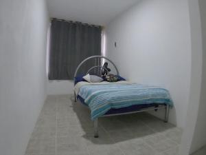 a small bed in a room with a window at Depto Zona UV Lagos Isleta 103 in Xalapa +14 photos