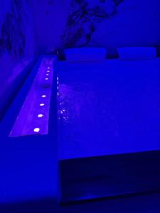 フォッジャにあるSN Luxury Room & Spaの青いライトが付いたベンチのある暗い部屋
