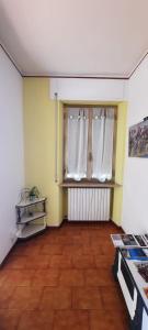 an empty room with a window with white curtains at A casa di Emma in Nereto