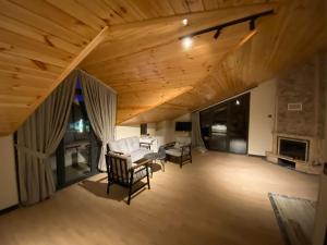 a large living room with a wooden ceiling and chairs at Ağva Capella Hideaway Hotel in Şile