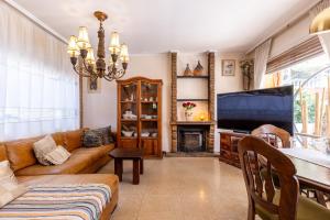 a living room with a couch and a television at Villa Frades in Salou