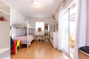 a bedroom with bunk beds and a desk with a desk at Villa Frades in Salou