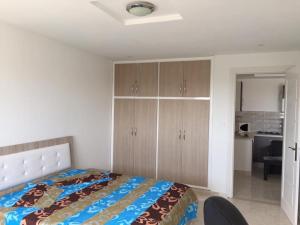 a bedroom with a bed and wooden cabinets at S1 meublé kelibia la Blanche in Kelibia