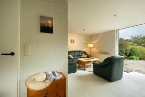 a living room with two chairs and a table at De Duiker in Wolphaartsdijk