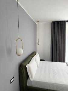 a bedroom with a bed with a green couch at Casa margherita in Bova Marina