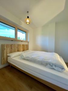 Postel nebo postele na pokoji v ubytování Seeblick Quartier