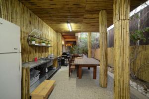 a kitchen with wooden walls and a table and a refrigerator at La Villa Eilat in Eilat