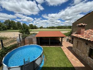 a swimming pool in the yard of a house at De Sol A Sol in Hornillos del Camino +7 photos