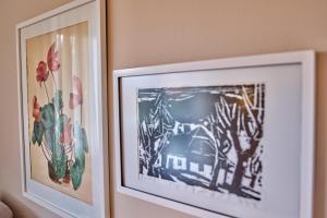 two pictures of flowers are hanging on a wall at Haus Carola in Bodenmais +26 photos