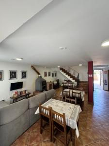 a living room with a couch and tables and chairs at De Sol A Sol in Hornillos del Camino