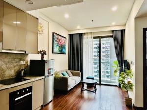 a kitchen and a living room with a couch at Ruby Homestay Vip Oceanpark in Gia Lâm Pho