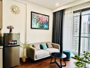 a living room with a couch and a large window at Ruby Homestay Vip Oceanpark in Gia Lâm Pho