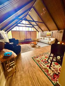 a living room with blue couches and a rug at Pasha Nova in Murree