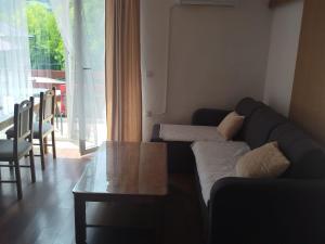 a living room with a couch and a table at Apartman ANNA in Jajce +11 photos