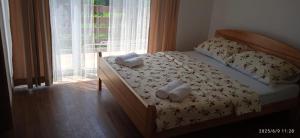 a bedroom with a bed with two towels on it at Apartman ANNA in Jajce