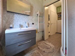 a bathroom with a sink and a mirror at Appartamento Cristian Zucconi in Venturina Terme