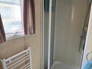 a shower stall in a bathroom with a window at Sylvan in Builth Wells