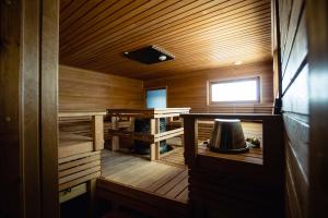a small wooden sauna with a bell in it at Suite Apartment with lake views in Lappajärvi