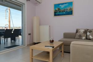 a living room with a couch and a table at Eirini luxury Apartments in Keramoti